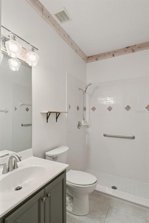 597 Sand Wedge Loop Apopka, FL 32712 - Photo 31 of 40 a bathroom with a sink a toilet and shower