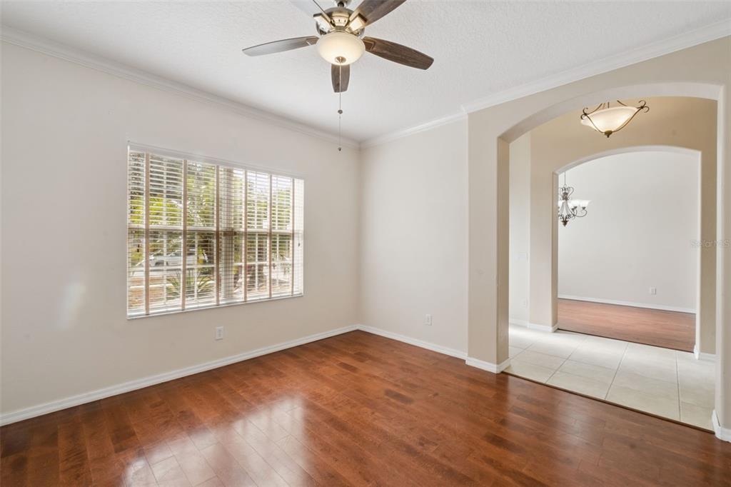 597 Sand Wedge Loop Apopka, FL 32712 - Photo 5 of 40 a view of an empty room with wooden floor and a window