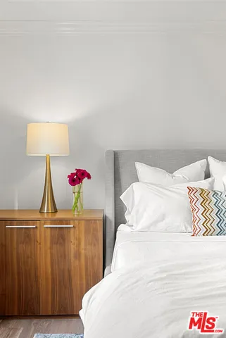 a bedroom with a bed and a lamp