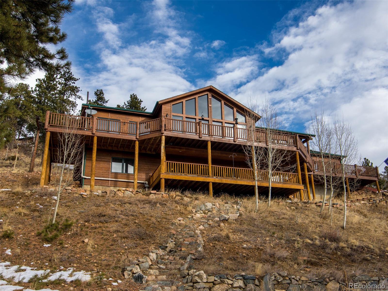 850 Royal Ridge Drive Bailey, CO 80421 - Photo 1 of 35 a view of house with a large window and a yard