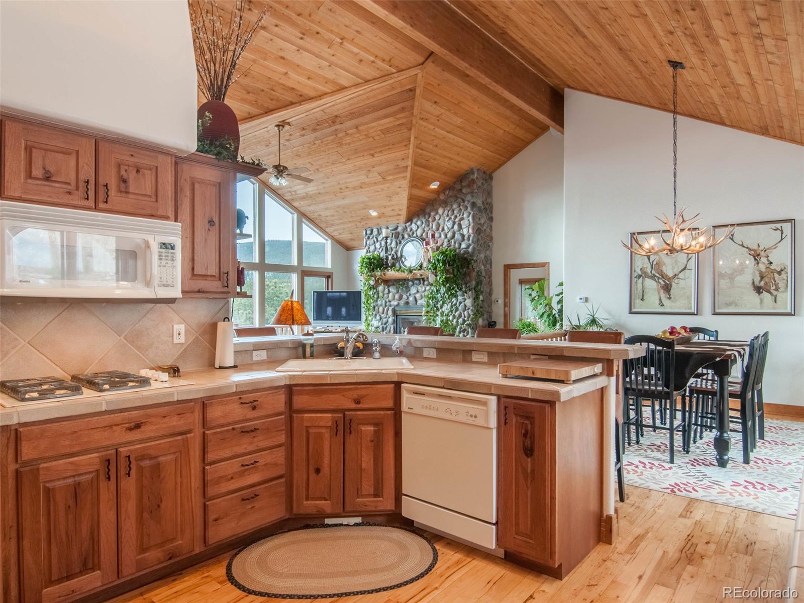 850 Royal Ridge Drive Bailey, CO 80421 - Photo 14 of 35 a kitchen with a sink cabinets and wooden floor