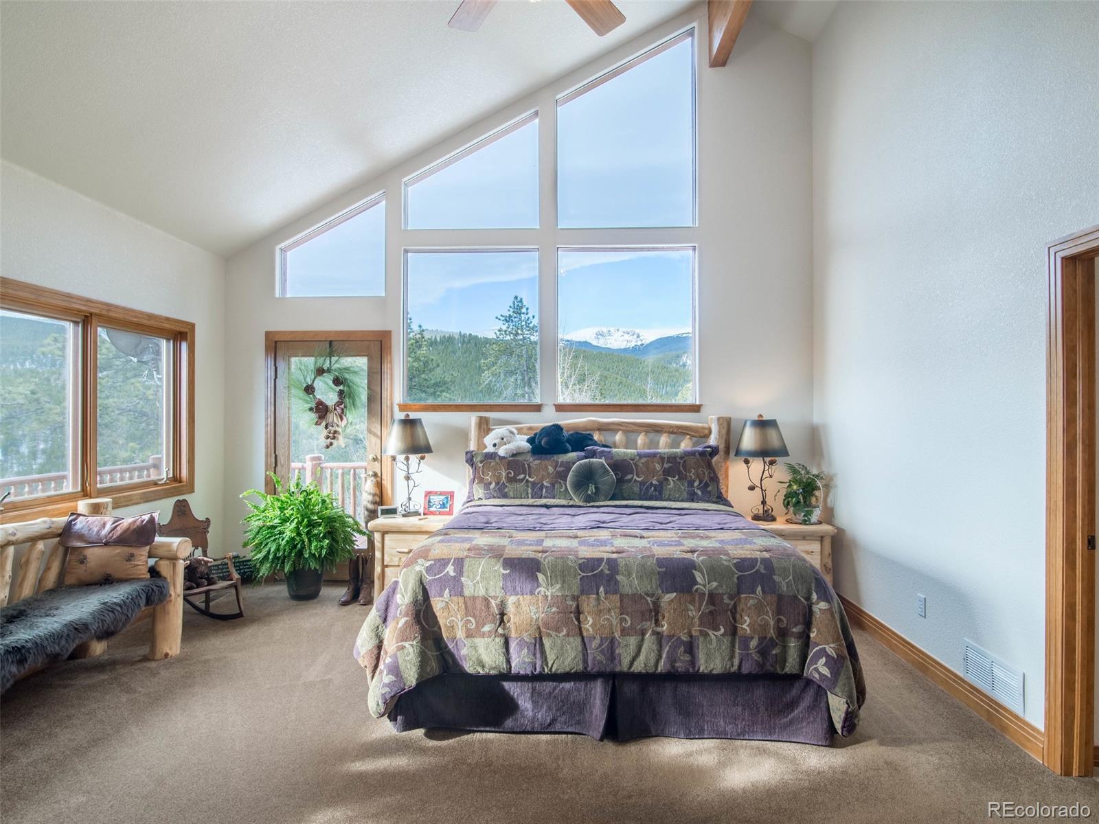 850 Royal Ridge Drive Bailey, CO 80421 - Photo 19 of 35 a bedroom with a bed and a large window