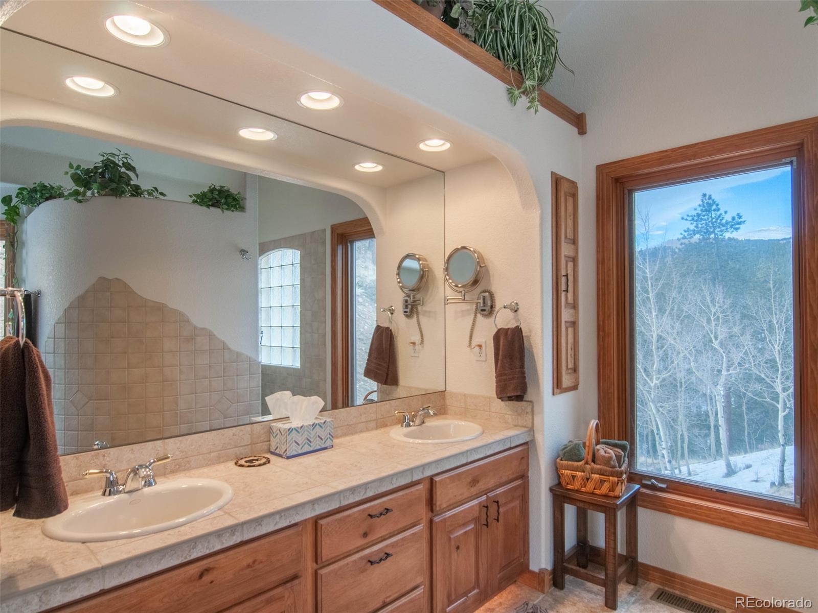 850 Royal Ridge Drive Bailey, CO 80421 - Photo 21 of 35 a bathroom with a double vanity sink and a mirror
