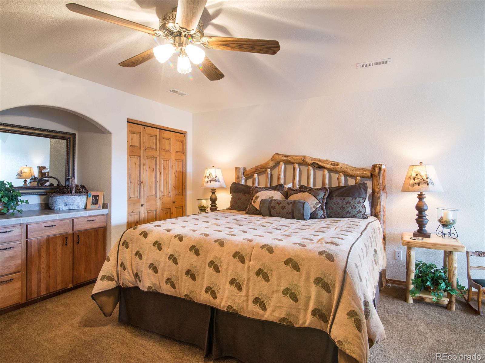 850 Royal Ridge Drive Bailey, CO 80421 - Photo 23 of 35 a bedroom with a bed and a chandelier