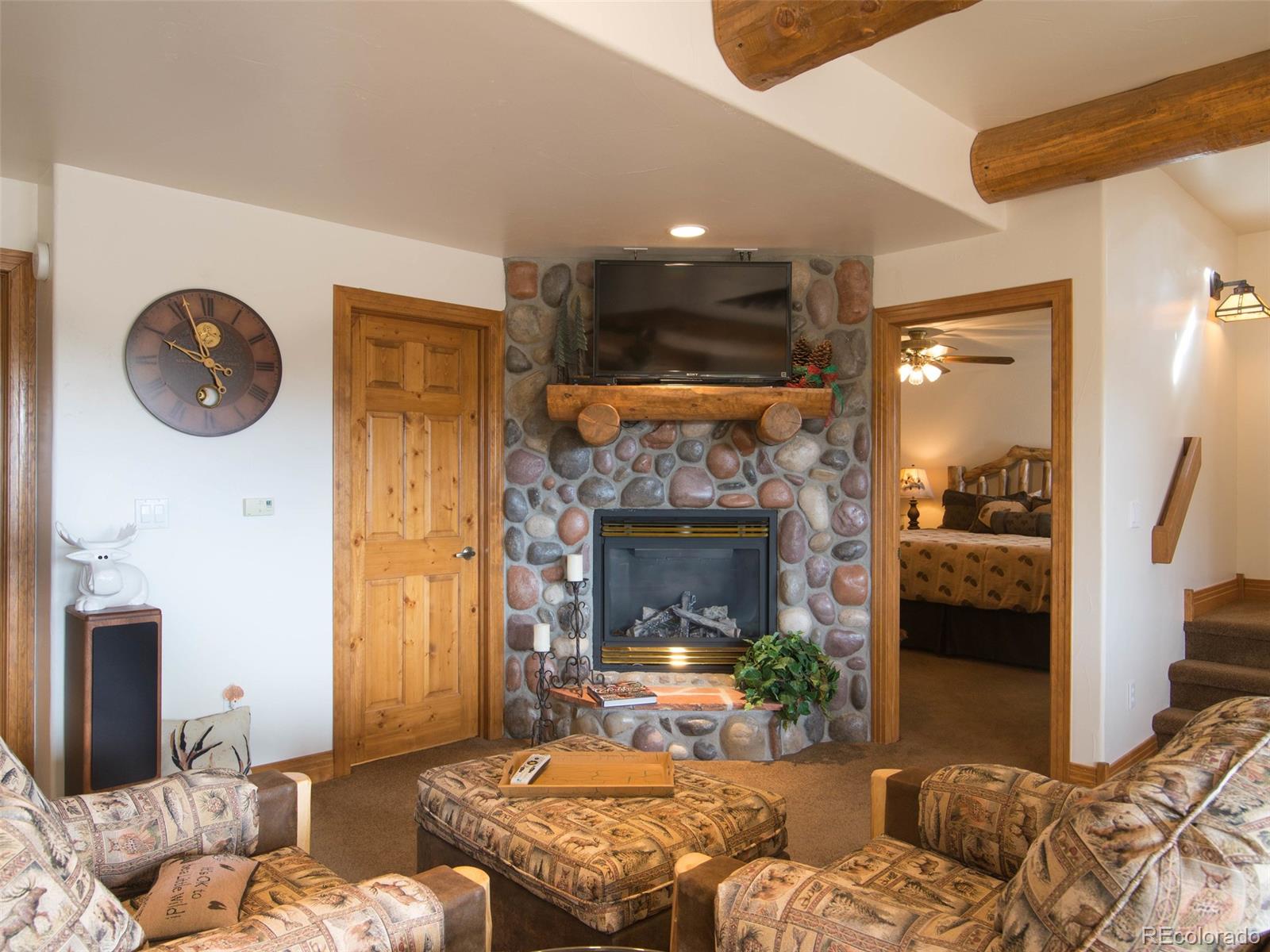 850 Royal Ridge Drive Bailey, CO 80421 - Photo 32 of 35 a bedroom with a bed and a fireplace