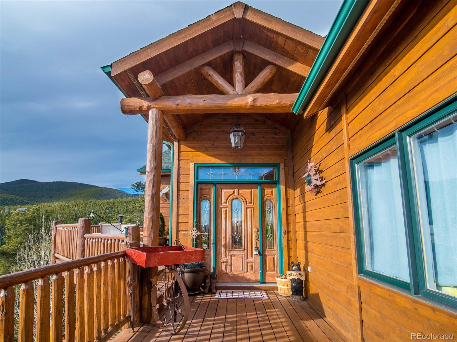 850 Royal Ridge Drive Bailey, CO 80421 - Photo 4 of 35 a view of a balcony with furniture and wooden floor