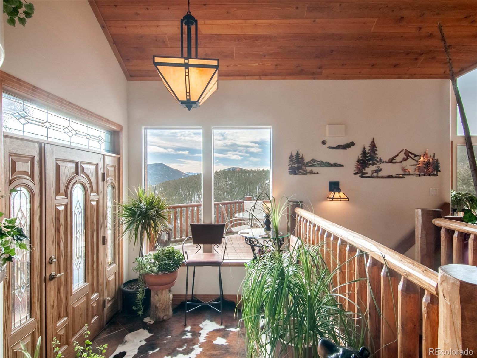 850 Royal Ridge Drive Bailey, CO 80421 - Photo 6 of 35 a very nice looking room with a large window and potted plants