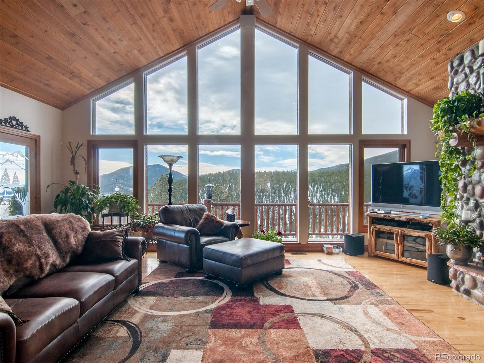 850 Royal Ridge Drive Bailey, CO 80421 - Photo 8 of 35 a living room with furniture and a floor to ceiling window