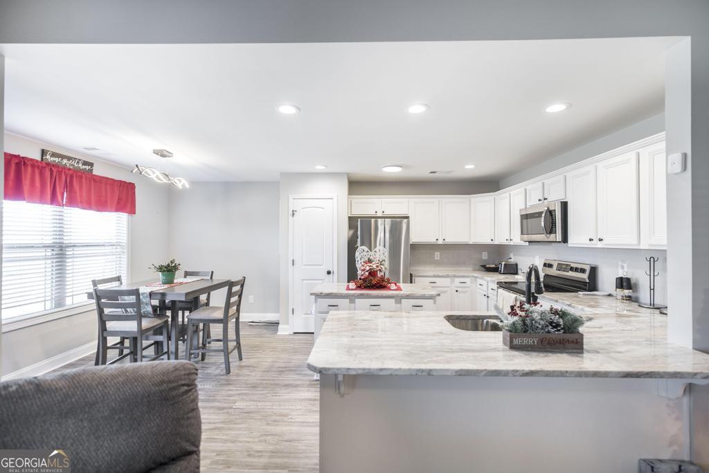 132 Sadie Heights Boulevard Perry, GA 31069 - Photo 11 of 29 a view of kitchen with kitchen island dining table and chairs