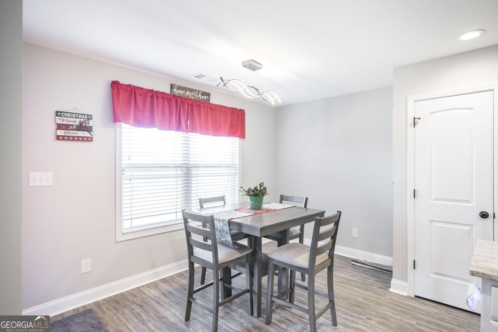 132 Sadie Heights Boulevard Perry, GA 31069 - Photo 12 of 29 a view of a dining room with furniture window and wooden floor