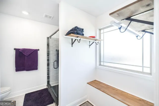 a bedroom with a large bed and a ceiling fan