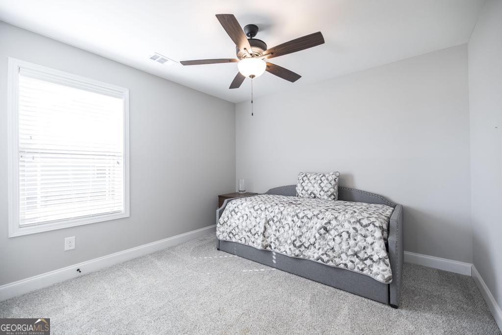 132 Sadie Heights Boulevard Perry, GA 31069 - Photo 22 of 29 a bedroom with a bed and window