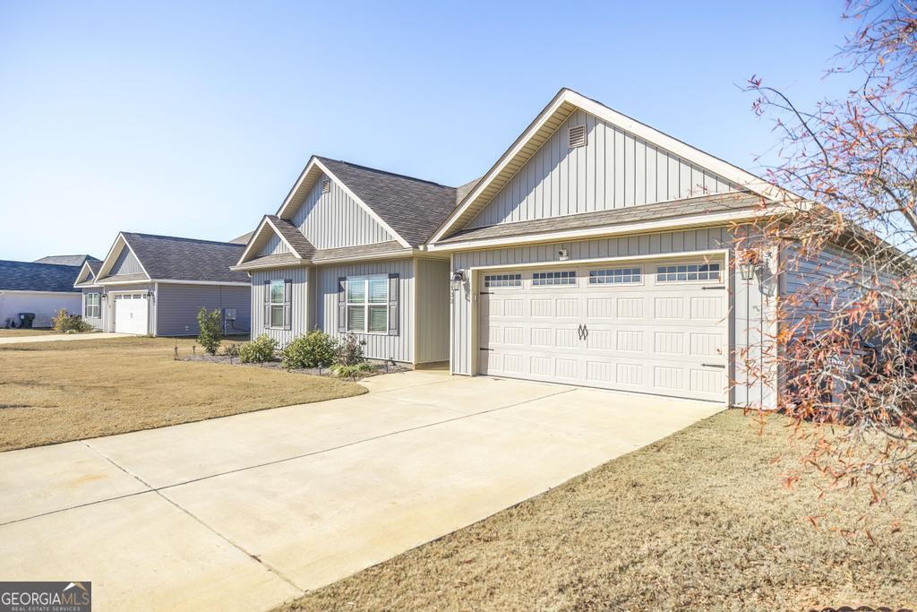 132 Sadie Heights Boulevard Perry, GA 31069 - Photo 5 of 29 a front view of a house with a yard and garage
