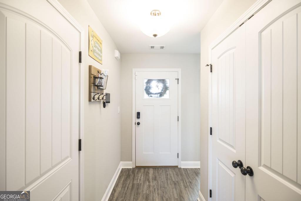 132 Sadie Heights Boulevard Perry, GA 31069 - Photo 7 of 29 a view of a hallway with wooden floor and closet area