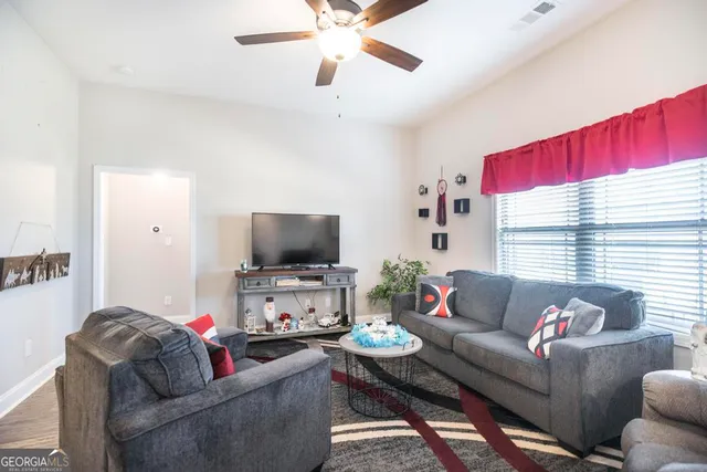 a living room with furniture and a flat screen tv