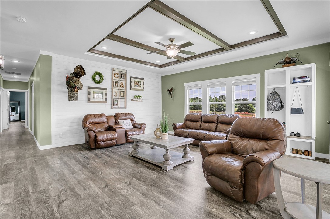 615 Wilson Road Central, SC 29630 - Photo 13 of 50 Exquisite ceiling trimwork accents the expansive living space featuring durable wide-plank flooring.