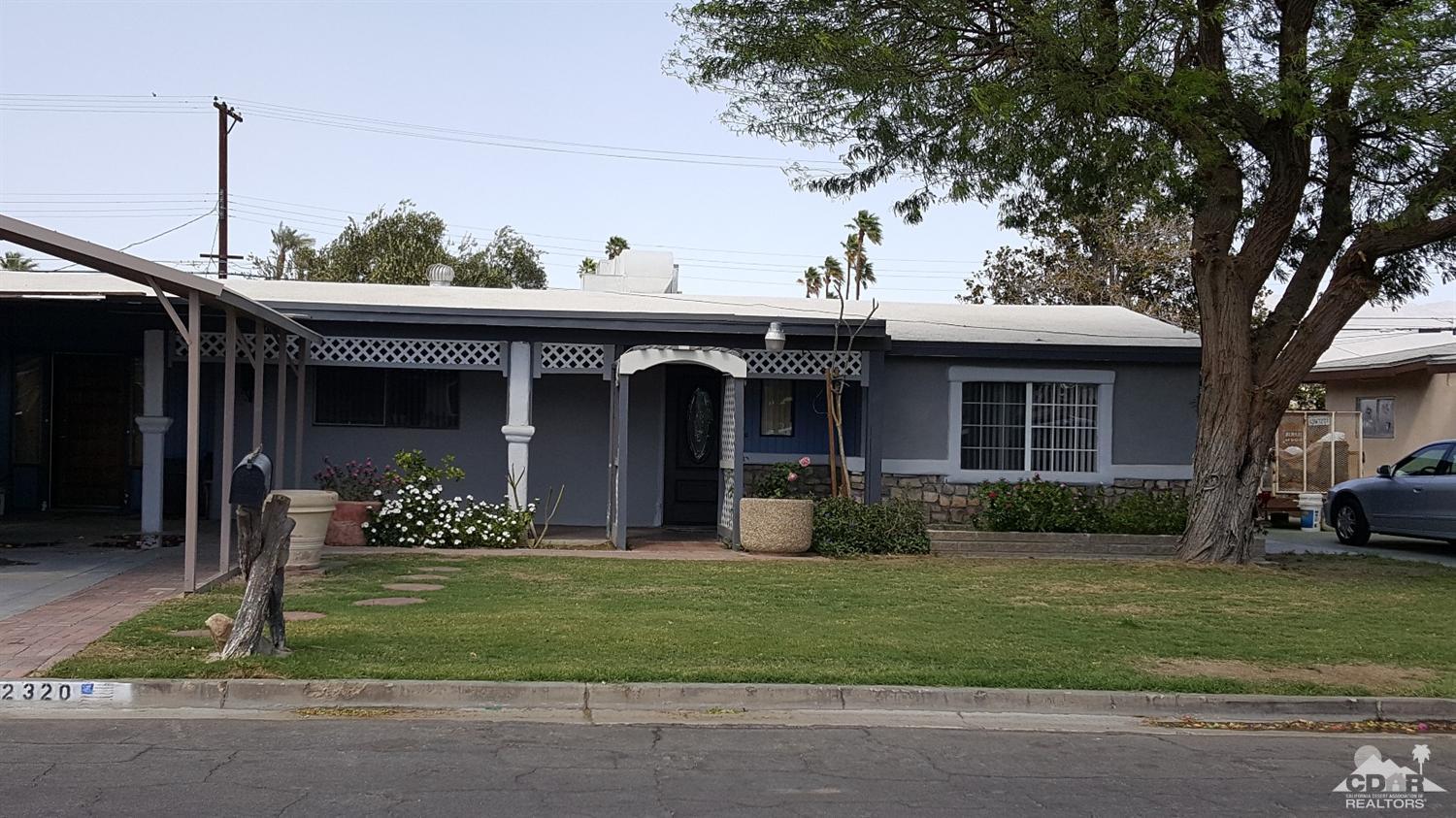 82320 Luce Court Indio, CA 92201 - Photo 1 of 11 a front view of a house with a yard