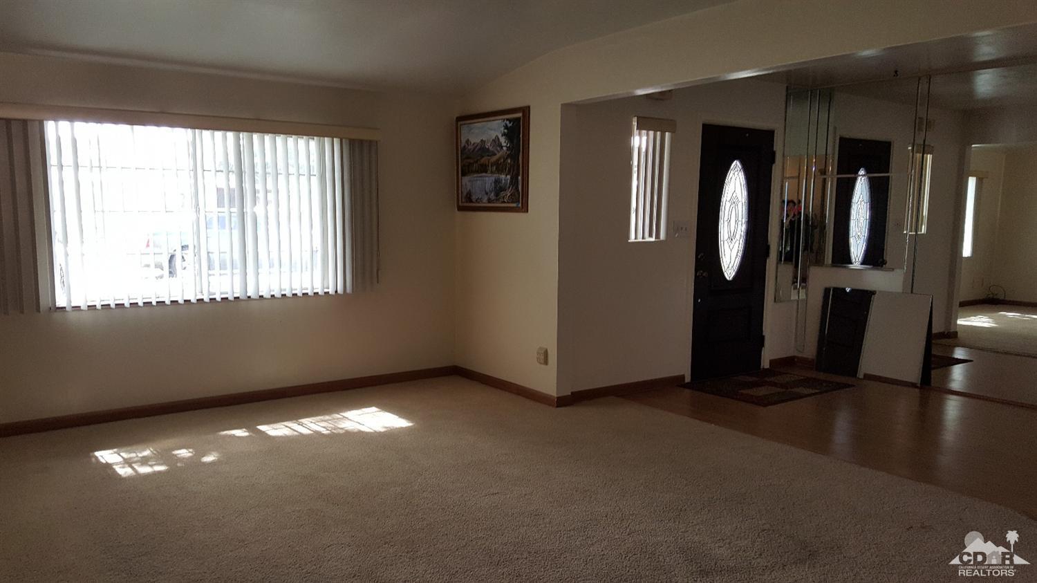 82320 Luce Court Indio, CA 92201 - Photo 4 of 11 a view of an empty room with glass door and windows