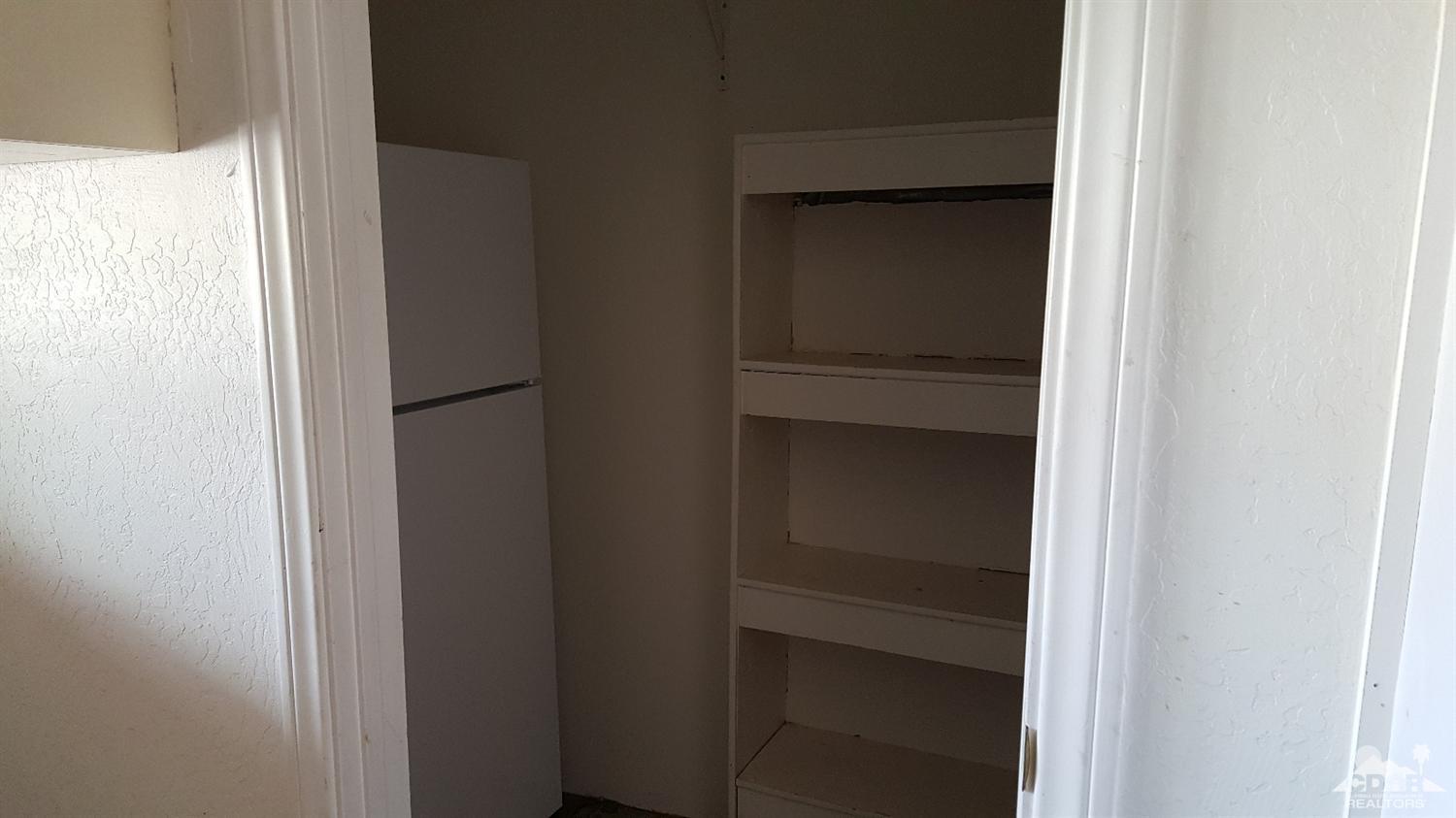 82320 Luce Court Indio, CA 92201 - Photo 9 of 11 a view of walk in closet with empty racks