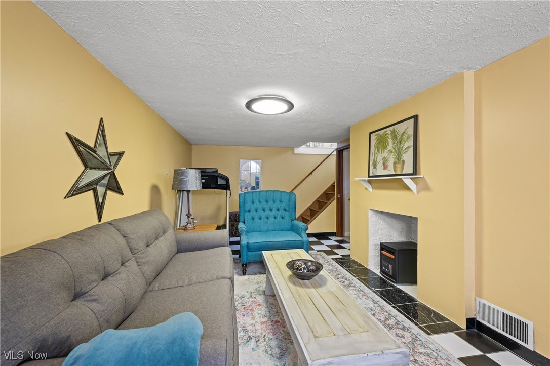 5100 Edenhurst Road Cleveland, OH 44124 - Photo 25 of 35 Living room with stairway and a textured ceiling