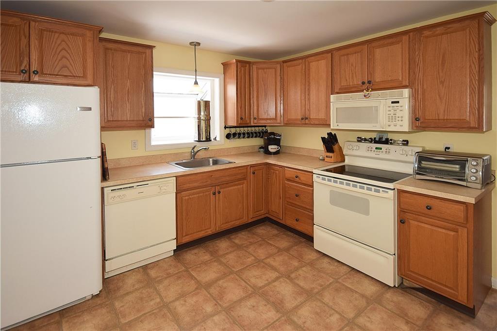 32 Spring Street Vernon, CT 06066 - Photo 1 of 1 a kitchen with a white stove top oven sink and cabinets