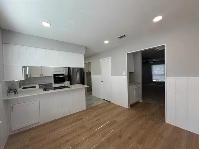 a kitchen with a sink and a stove top oven