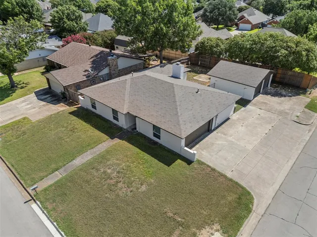 an aerial view of a house with a yard