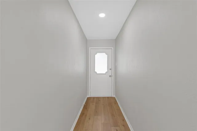 a view of hallway with wooden floor