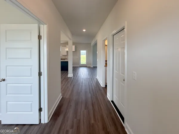a view of a hallway with wooden floor and staircase