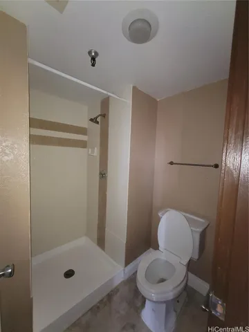 a bathroom with a toilet and a shower