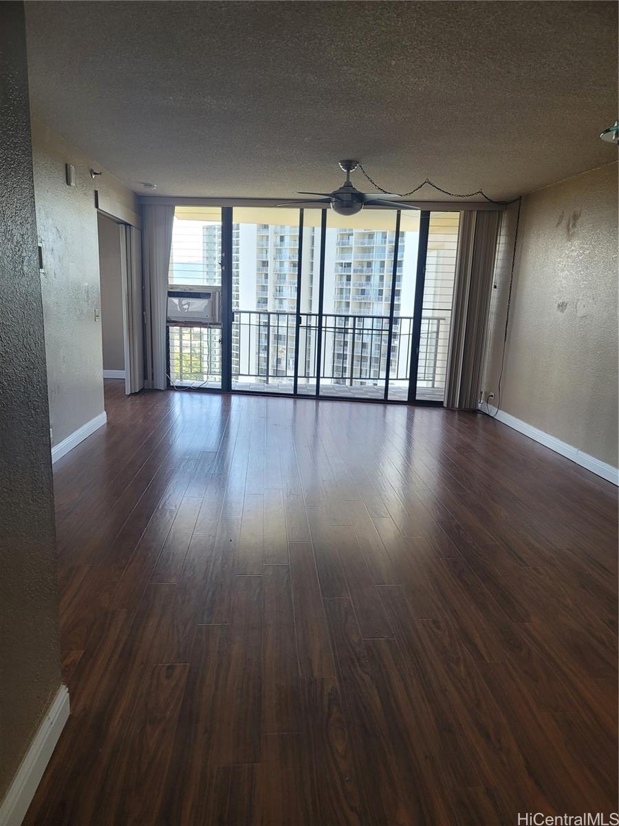 98-487 Koauka Loop, Unit B1603 Aiea, HI 96701 - Photo 2 of 20 wooden floor in an empty room with a window