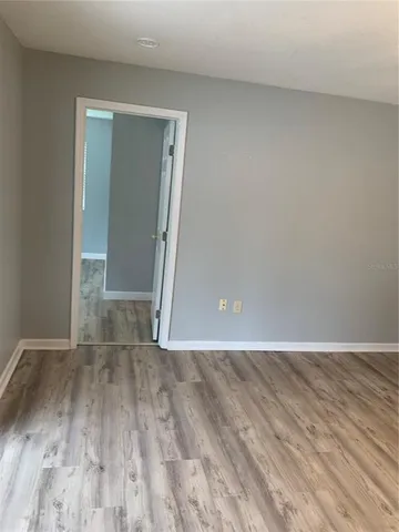 a view of an empty room and wooden floor