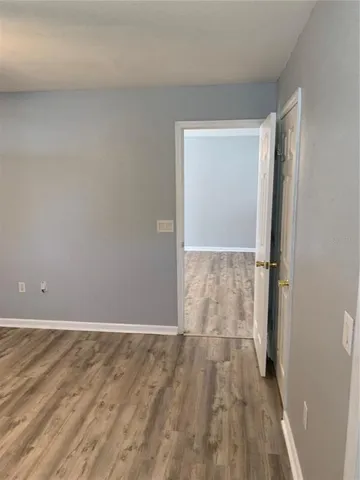 a view of a room with wooden floor