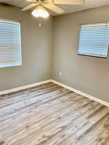 a view of a small space with wooden floor fan and window