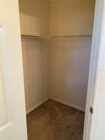 a view of a utility room with closet and racks