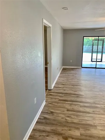 a view of a room with wooden floor and window