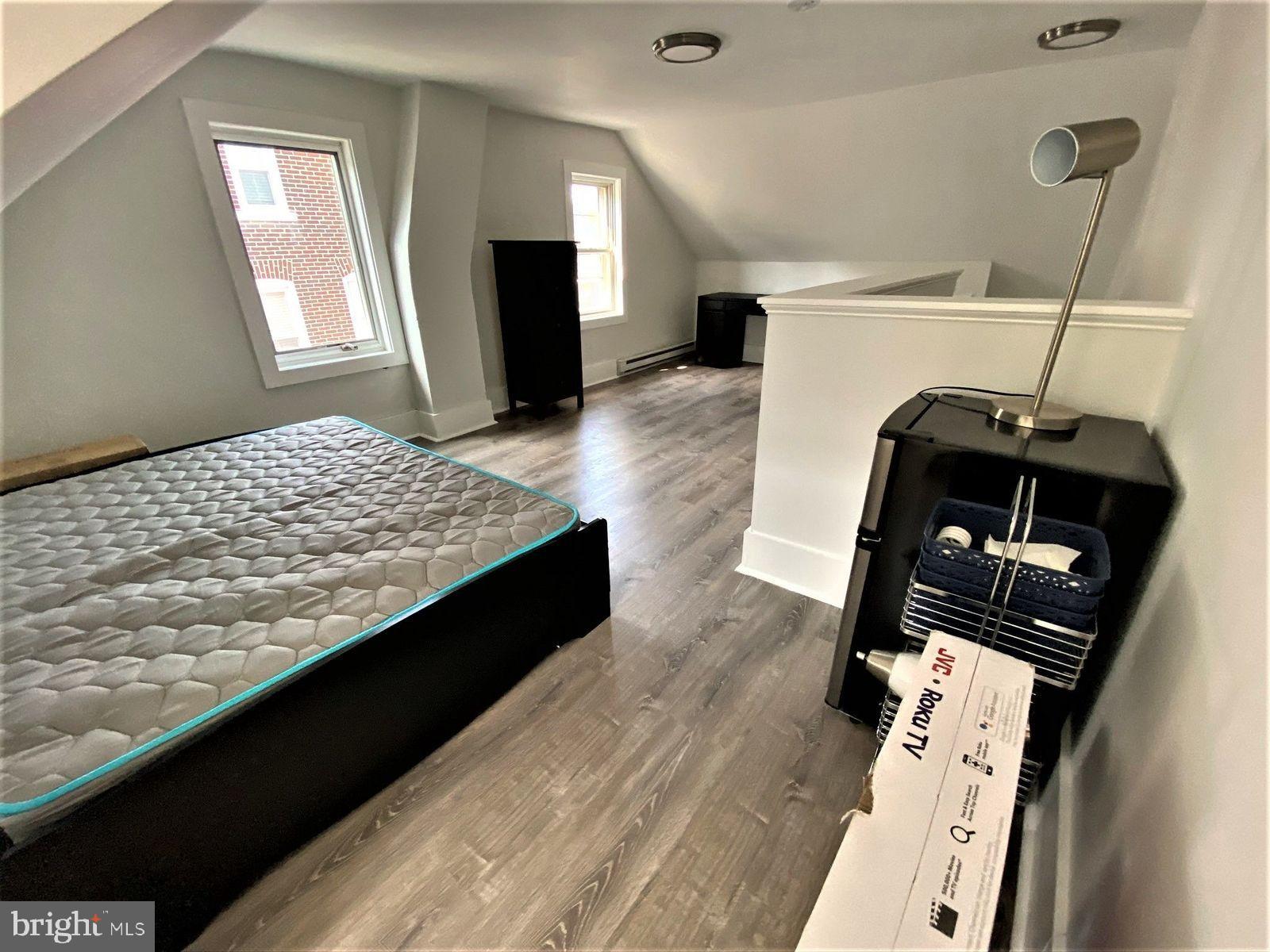 515 Thomas Street Bethlehem, PA 18015 - Photo 28 of 30 a living room with a bed and a television