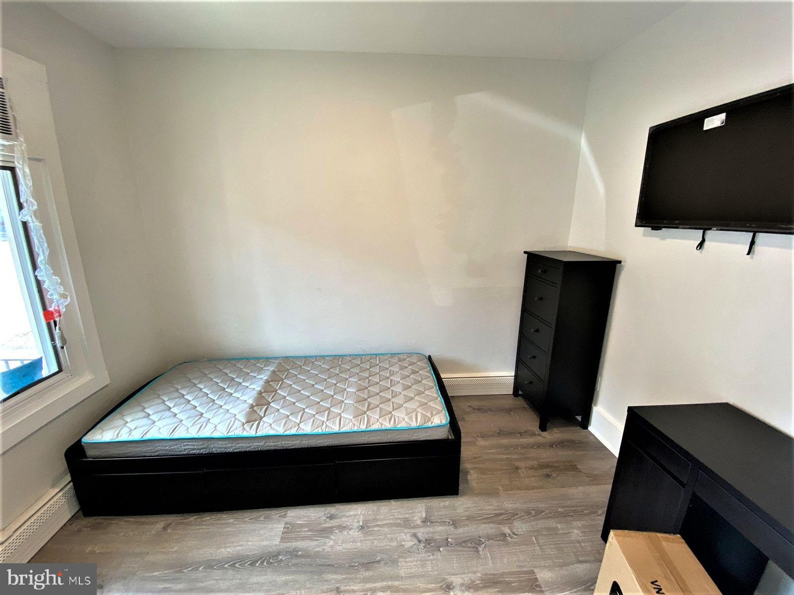515 Thomas Street Bethlehem, PA 18015 - Photo 10 of 30 a room with a bed and a flat screen tv