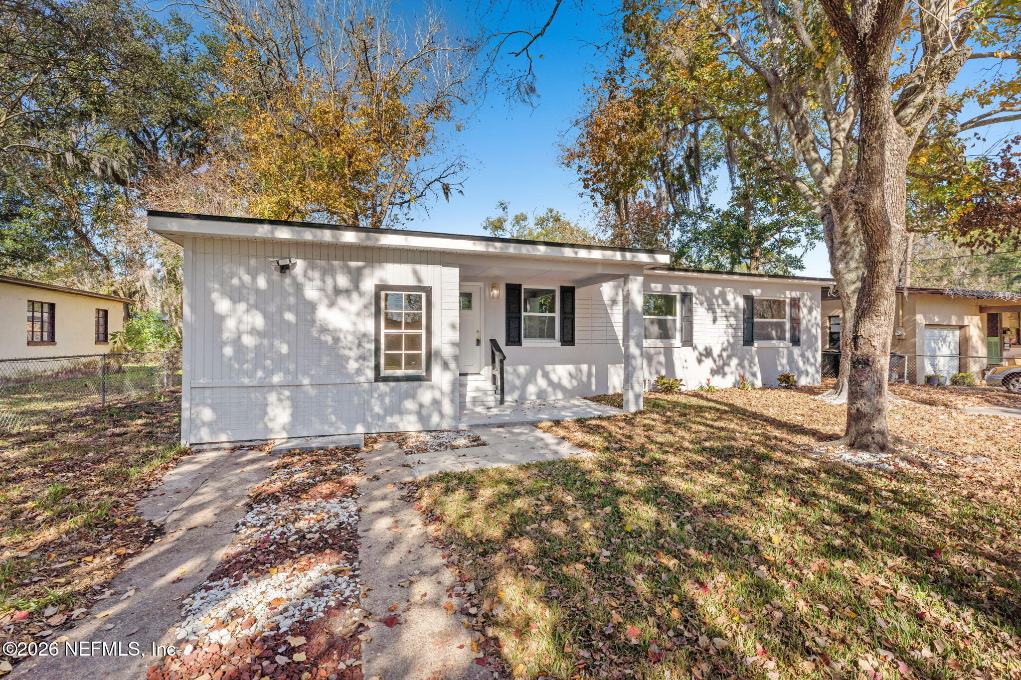 a front view of a house with yard patio and green space