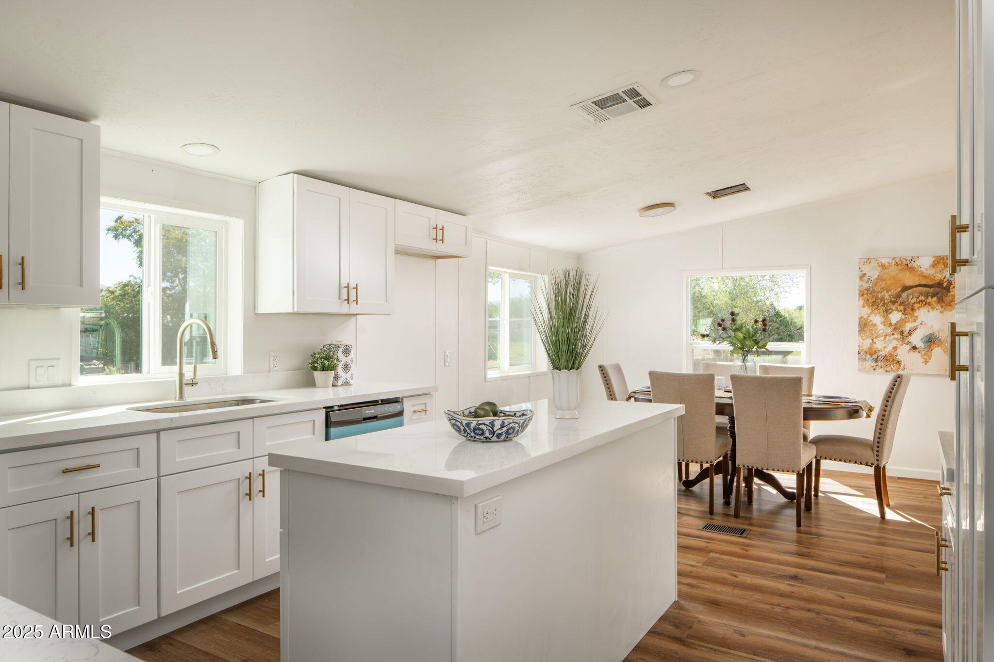 3278 East Ripple Road Camp Verde, AZ 86322 - Photo 12 of 33 a kitchen with a stove a sink a dining table and chairs