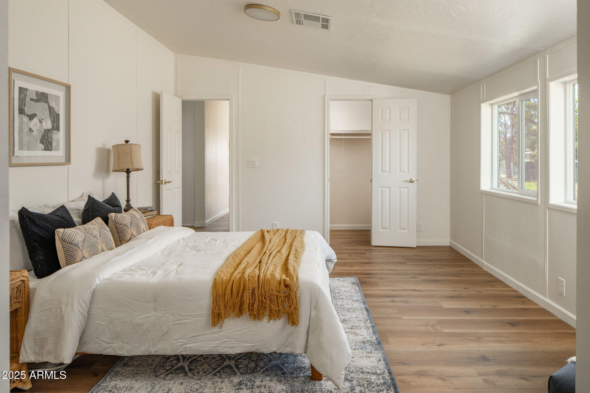 3278 East Ripple Road Camp Verde, AZ 86322 - Photo 16 of 33 a bedroom with a bed and wooden floor