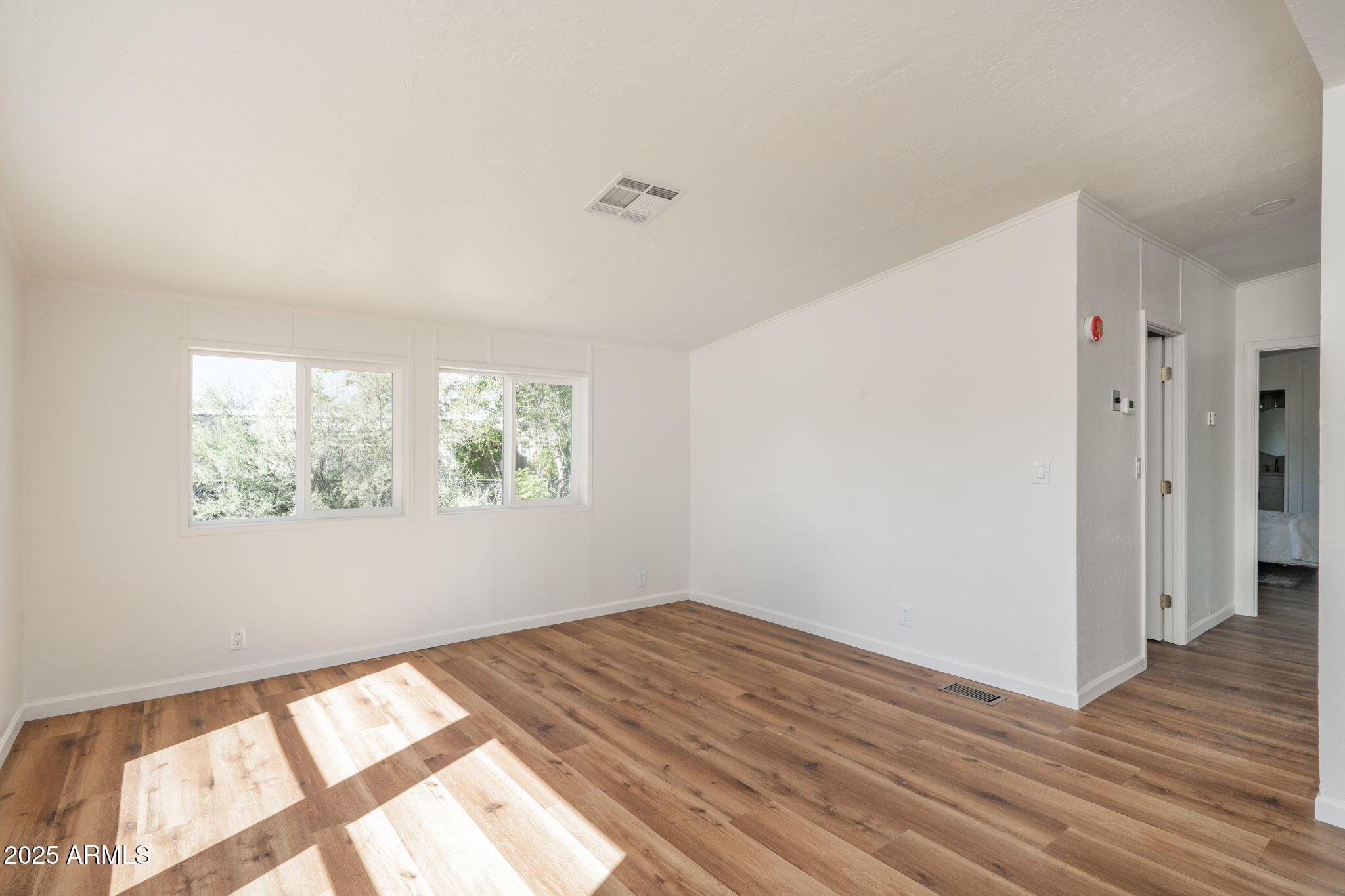 3278 East Ripple Road Camp Verde, AZ 86322 - Photo 23 of 33 an empty room with wooden floor and windows