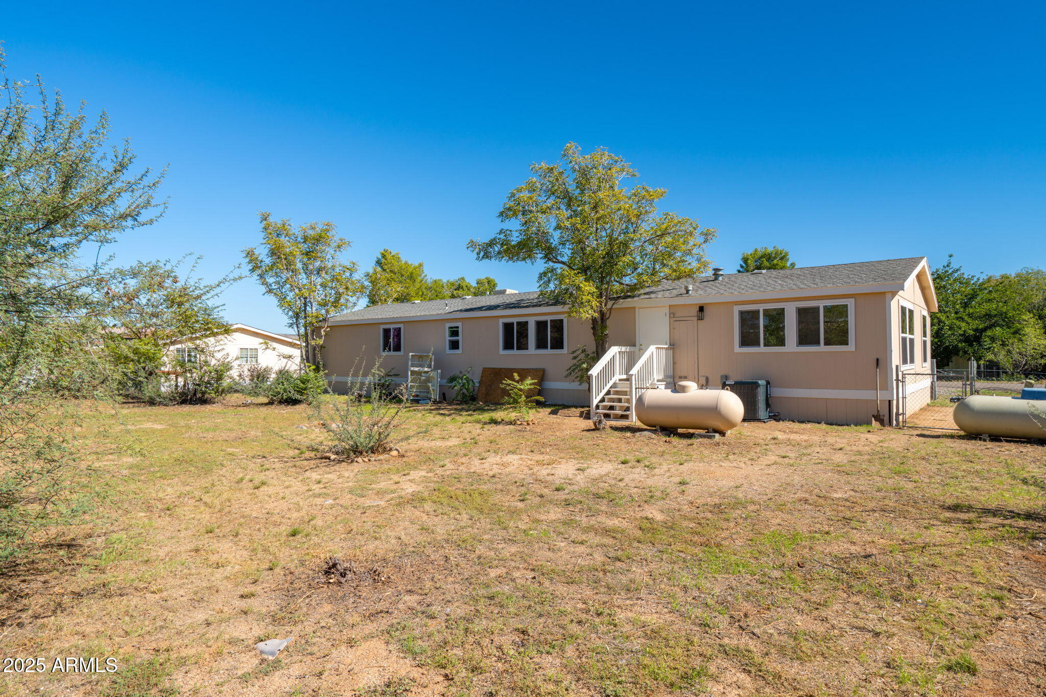 3278 East Ripple Road Camp Verde, AZ 86322 - Photo 33 of 33 a front view of a house with a yard and garage