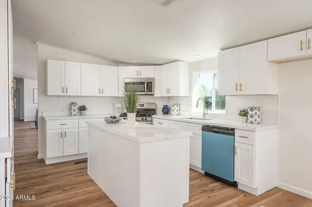 a kitchen with stainless steel appliances granite countertop a sink and cabinets