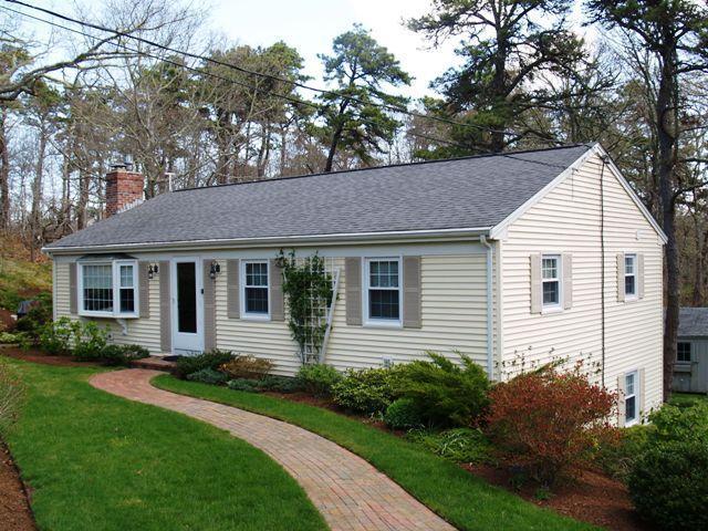 a view of a house with a yard and plants
