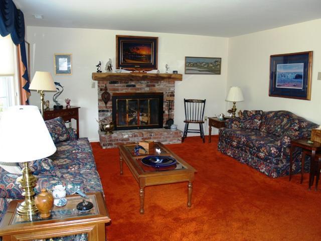 252 Training Field Road Chatham, MA 02633 - Photo 3 of 10 a living room with furniture a flat screen tv and a fireplace