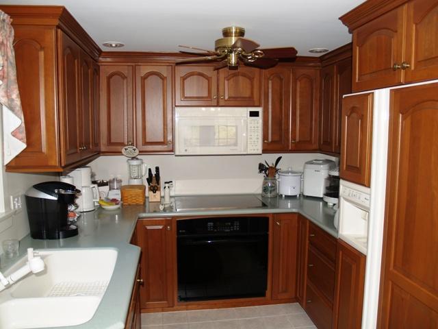 252 Training Field Road Chatham, MA 02633 - Photo 5 of 10 a kitchen with granite countertop a sink stove and cabinets