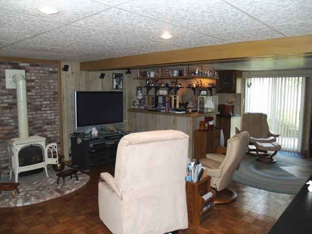 252 Training Field Road Chatham, MA 02633 - Photo 10 of 10 a living room with furniture a flat screen tv and floor to ceiling window