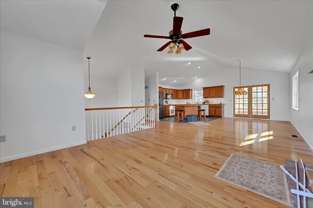 a view of a livingroom with a ceiling fan furniture and window