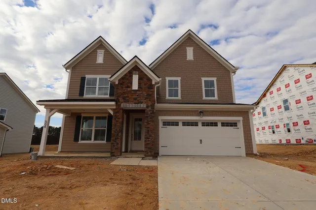 a front view of a house with a garage